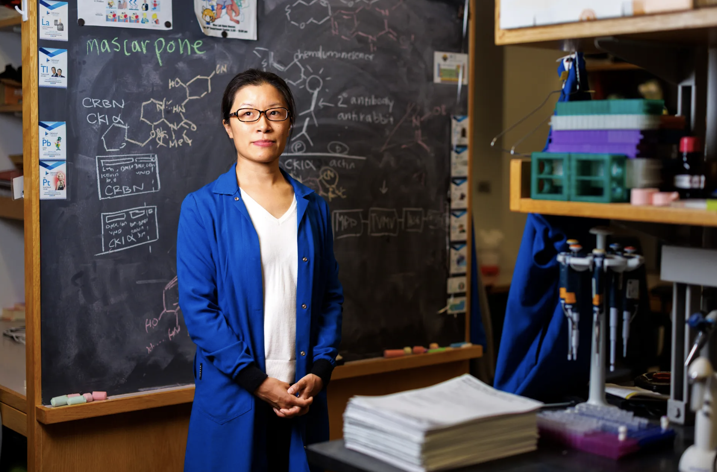 Christina Woo in front of a chalkboard