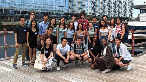 CCB undergraduates and faculty gather in front of a boat terminal