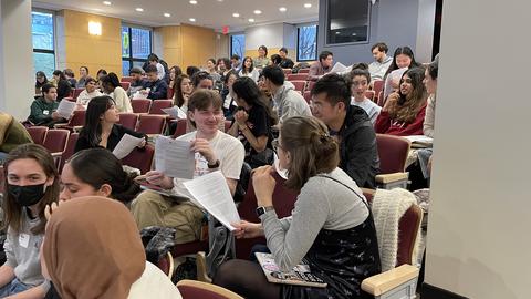 Chemistry students engaging in discussion in Pfizer lecture hall