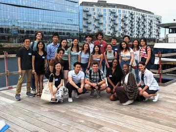 CCB undergraduates and faculty gather in front of a boat terminal