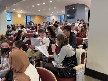 Chemistry students engaging in discussion in Pfizer lecture hall