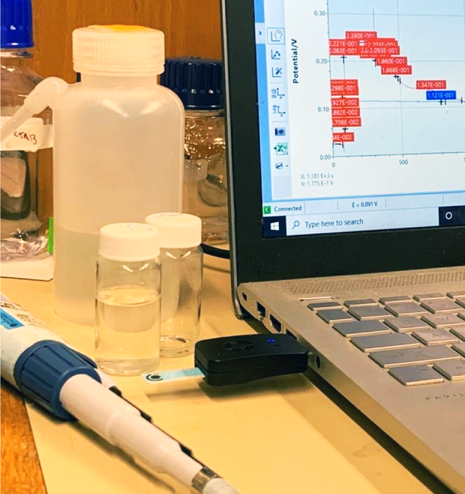 A photo of the ion sensor connected via USB to a laptop