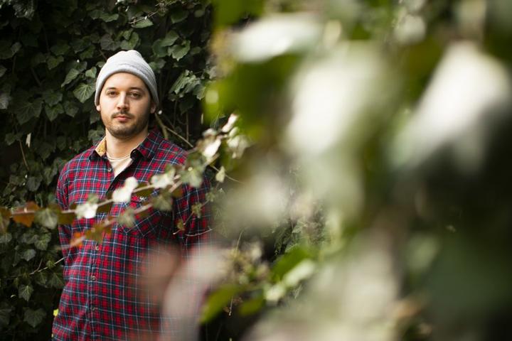 A photo of Eric Fell standing next to ivy