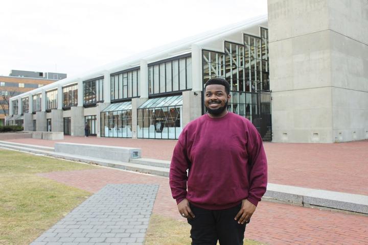 A photo of Laier-Rayshon Smith standing outside the Harvard Graduate School of Design