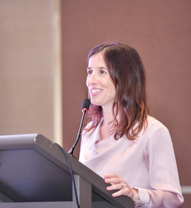 A photo of Heidi Vollmer-Snarr standing at a podium