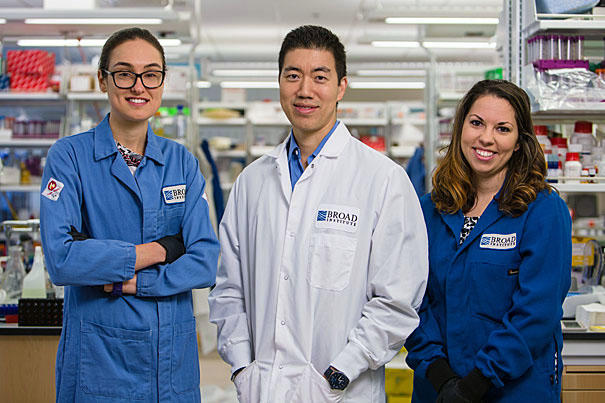 Holly stands with David Liu and Nicole Gaudelli in their lab at the Broad Institute