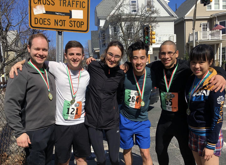Holly (third from left) is not the only runner in the Liu lab. Here, she embraces her lab and running mates after a Cambridge 5K