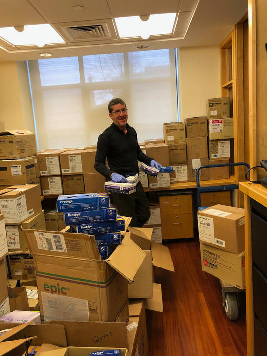 A photo of Russ Porter surrounded with boxes and equipment