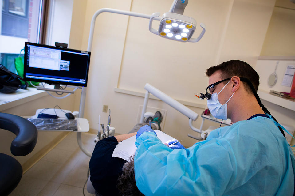 A photo of Dental School student Tom Ferlito treating a patient