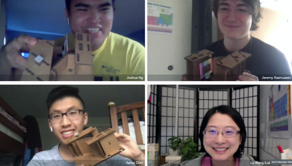 A screenshot of a Zoom conference with students holding up their homemade spectrometers