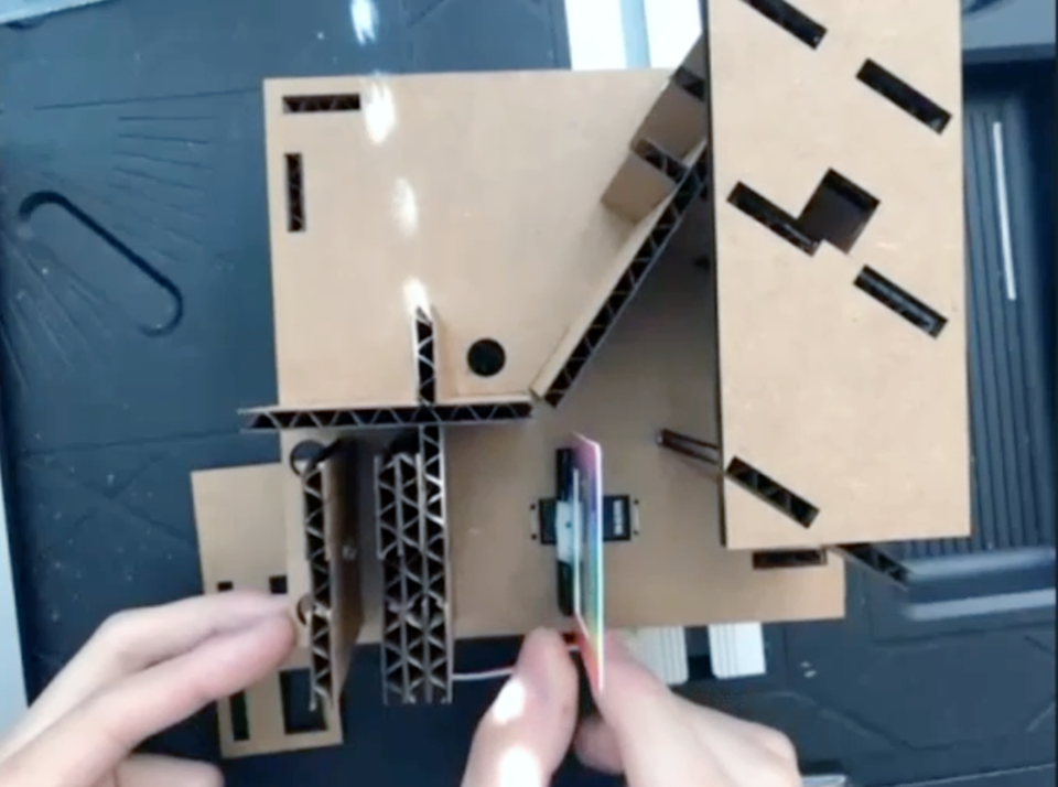 A screenshot of Alvin Hsu demonstrating how to construct a homemade spectrometer from cardboard