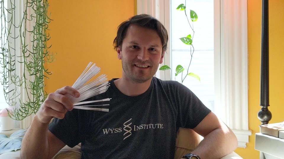 A photo of Richard Novak holding up his new nasal swabs