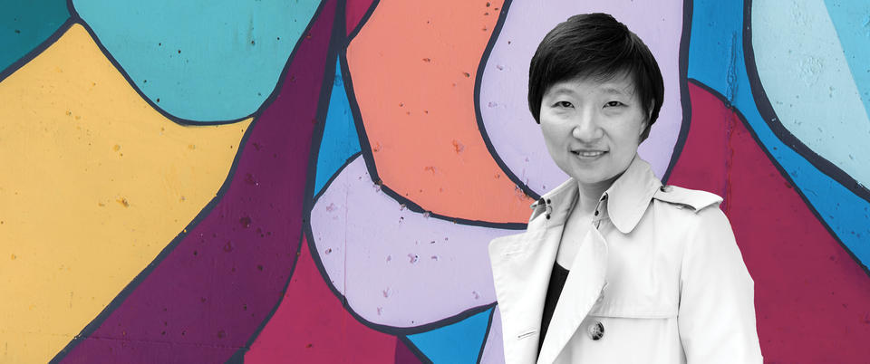 A black and white photo of Xiaowei over a colorful background