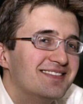 A headshot of Victor Ovchinnikov